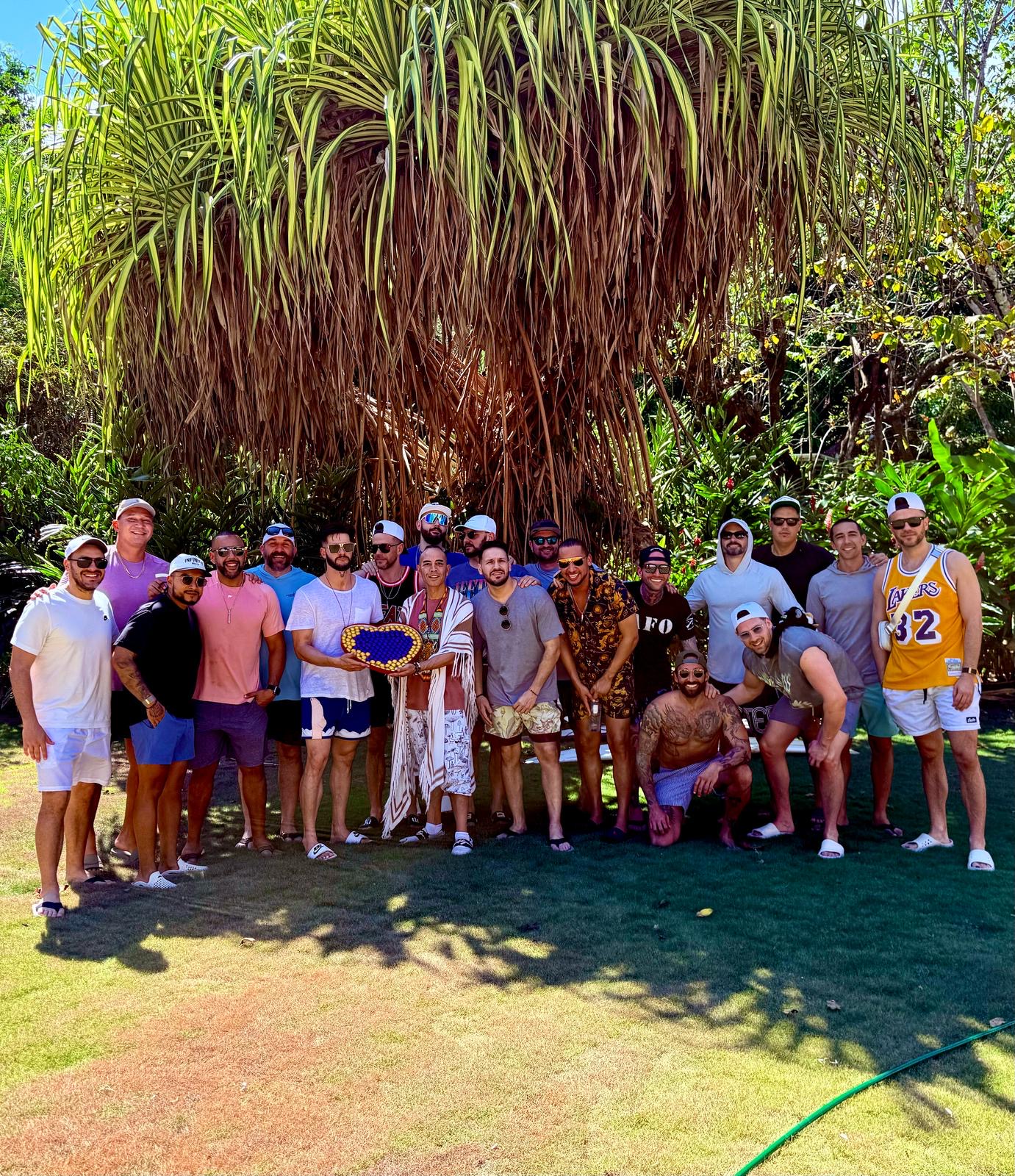 Participants gathered together beneath the palms at an earlier retreat