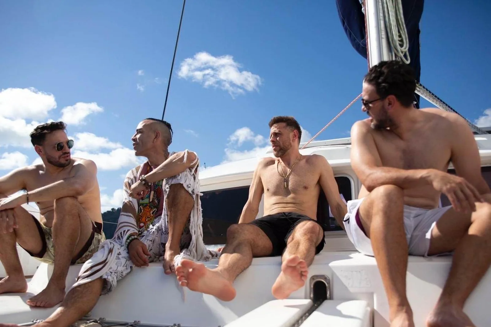 Guests on the deck of the boat with the gulf behind them.